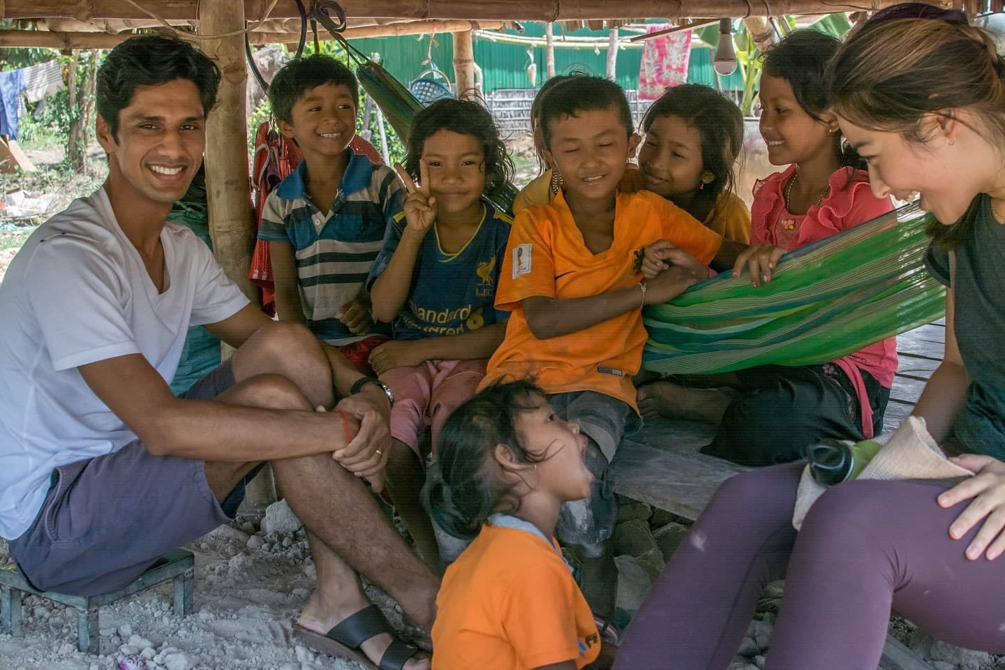 Yogi Madhav sitting and laughing with village children