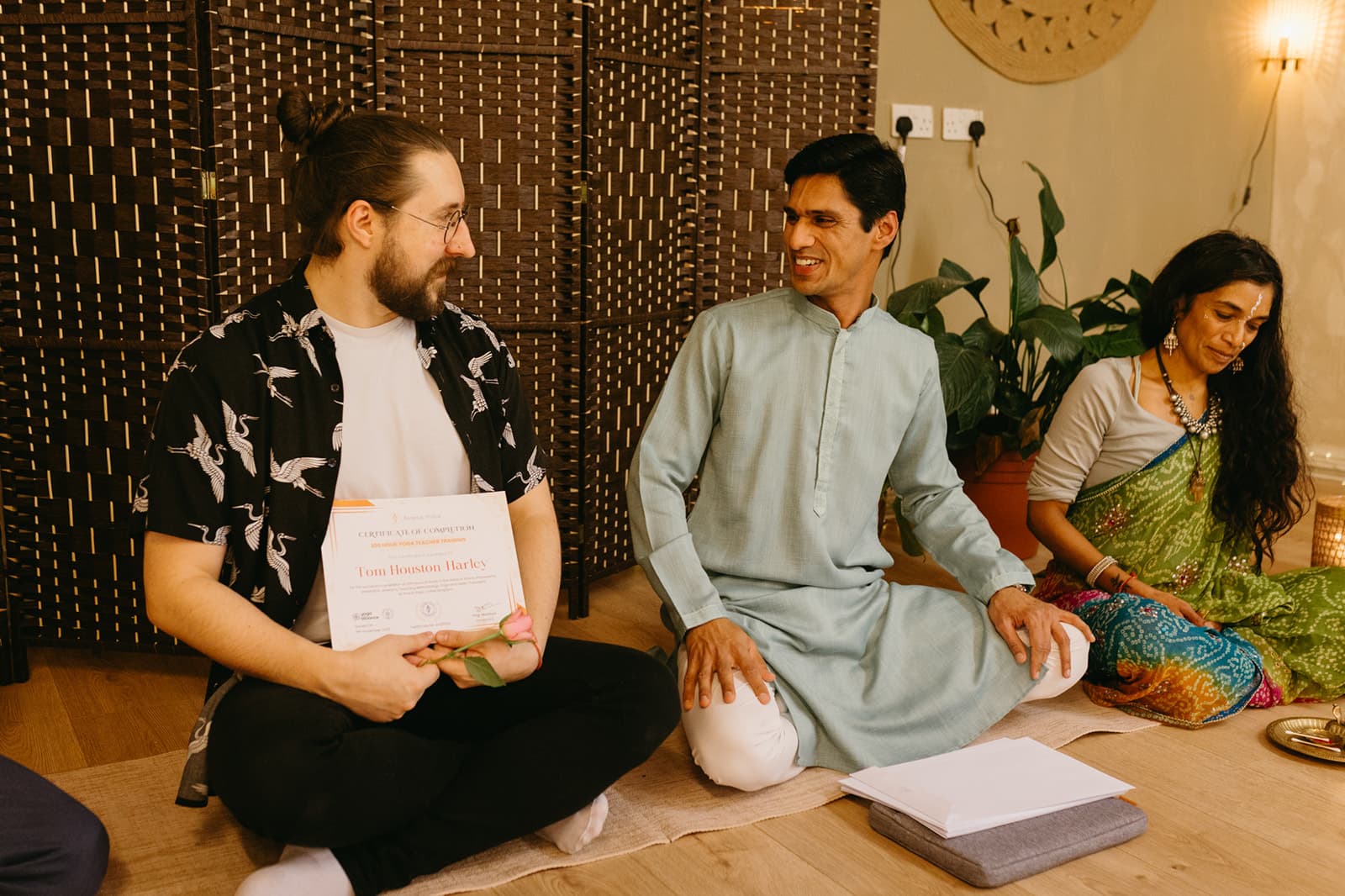 A graduate laughs with Yogi Madhav, certificate in hand