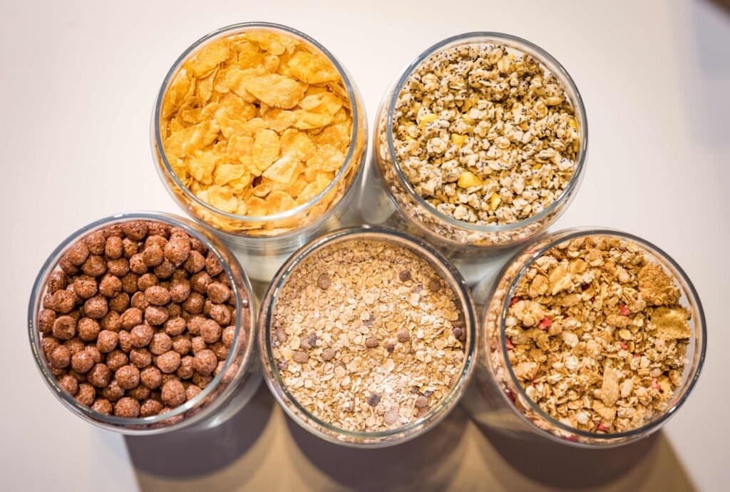 Jars of granola, nuts and seeds at breakfast