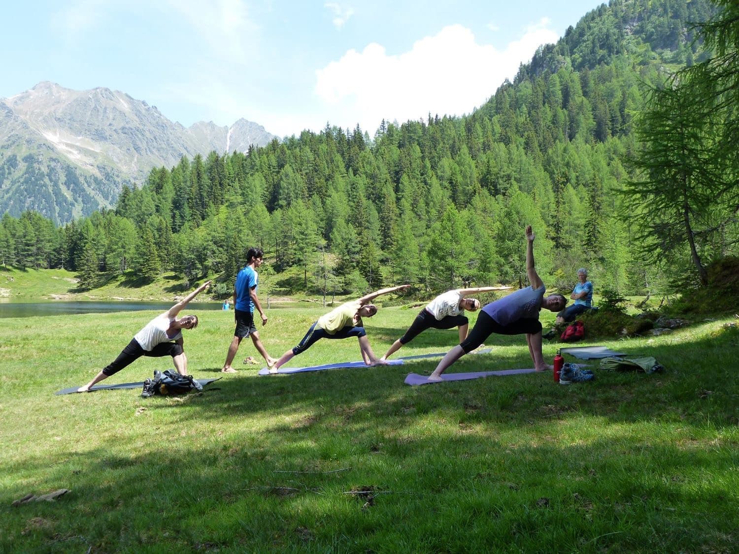 Yogi Madhav teaching a class beside an alpine lake in Austria
