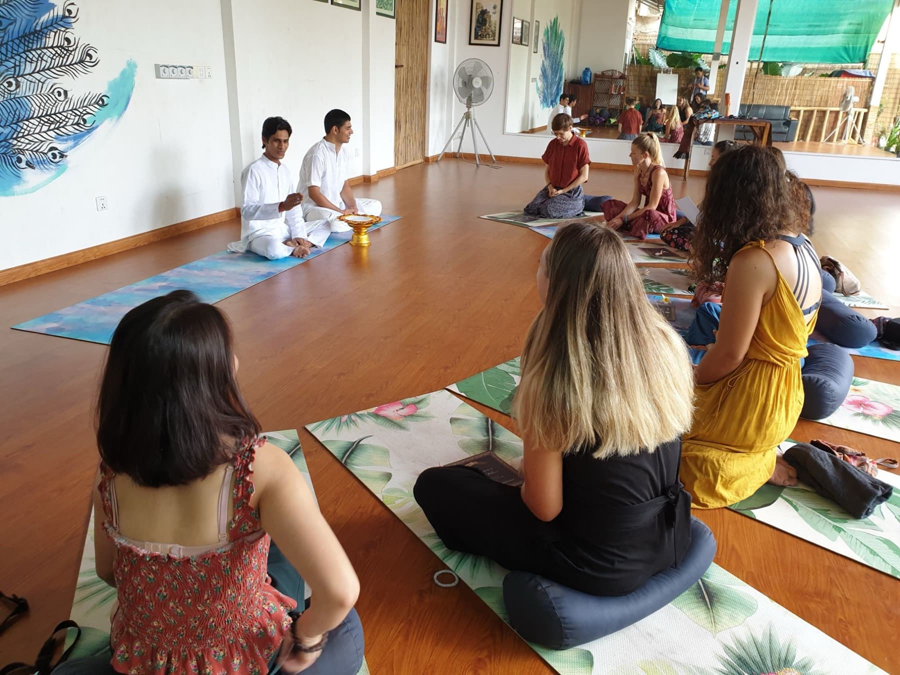 Yogi Madhav speaking to a circle of students at a closing ceremony in Cambodia