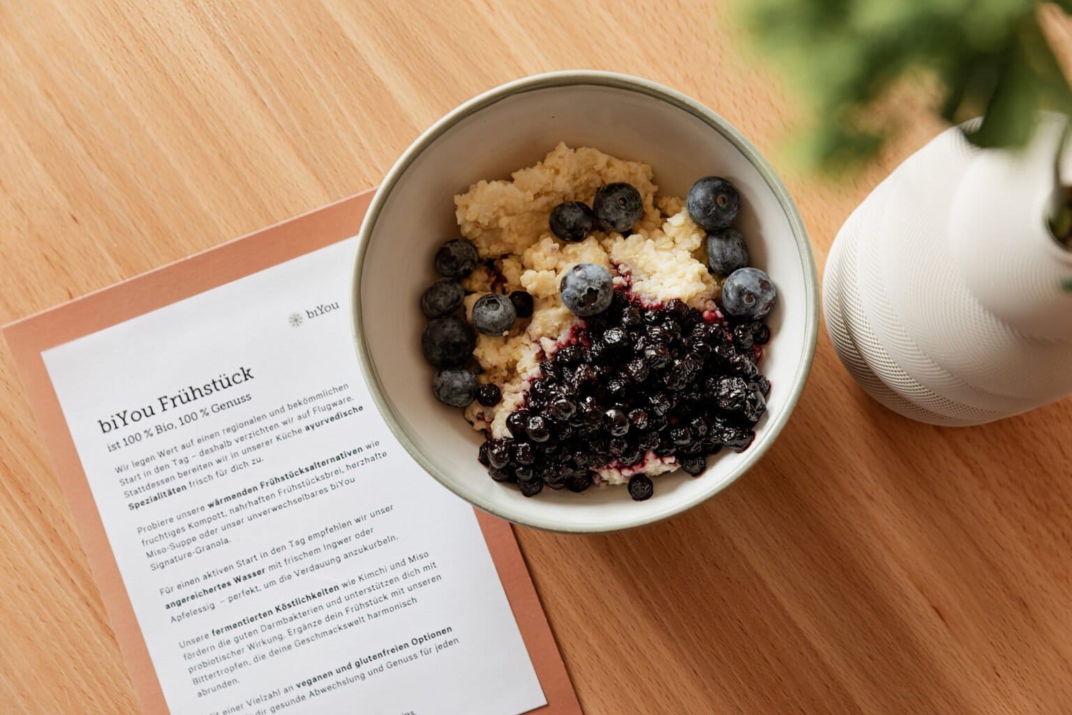 Porridge with blueberries served on a wooden table